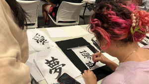 Person writing Japanese caligraphy