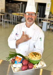 man holding bowl of mashed potatoes
