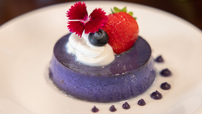 Ube flan with creme caramel and fresh fruit garnish