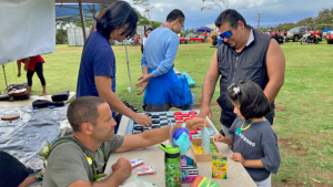 people standing and kneeling playing board games