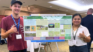 2 students holding map poster