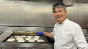 Chef Roy Yamaguchi with pancakes on the griddle