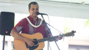 Osorio playing the guitar, singing