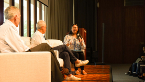 three people sitting on a stage