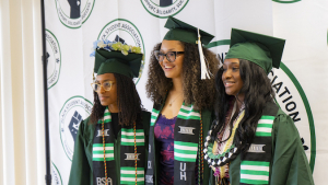 three women in graduation gowns