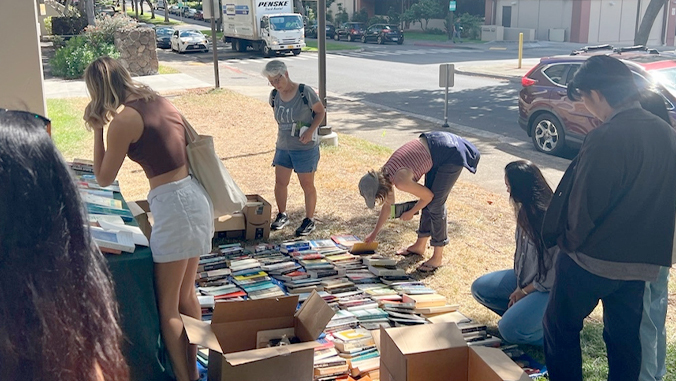 people sorting through books