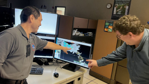 Two men looking at computer screen