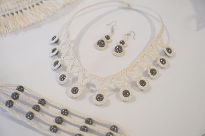 white woven jewelry with black pearls