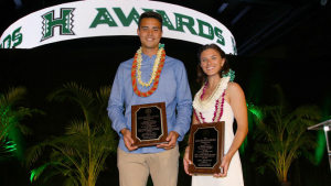 two people holding awards