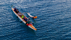 aerial of outrigger canoe paddlers in the ocean