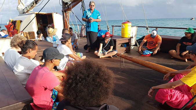 voyagers sitting on a canoe.