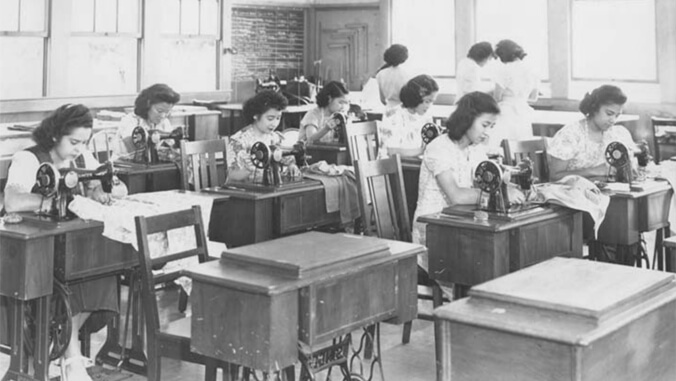Black and white of women in a sewing class