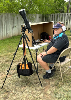 man looking through telescope