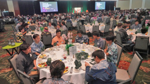 people sitting on tables in a ballroom