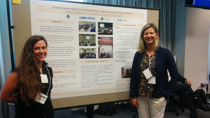pirkle and camara with a presentation board
