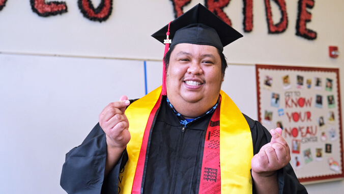 Sebastian wearing commencement cap and gown