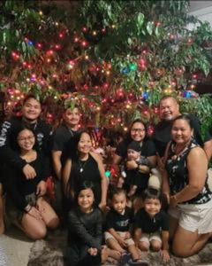 a family in front of a christmas tree