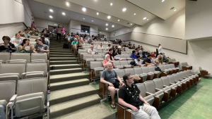people sitting in a large auditorium