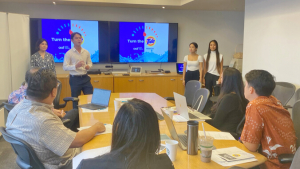 people standing presenting in front of a screen