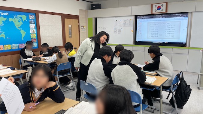 Macusi teaching students in Korea.