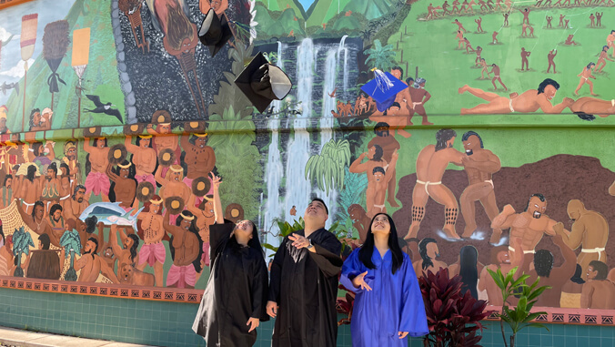 Dagdag family tossing their graduation caps