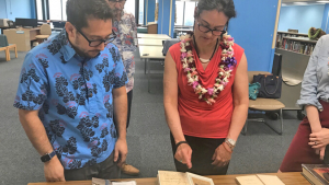 people looking at books in a library