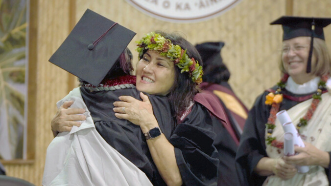 woman hugging graduate