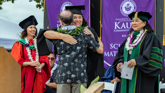 Margaret Sanchez hugging someone at commencement ceremony
