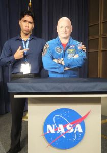 cataluna posing with a standee of astronaut scott kelly