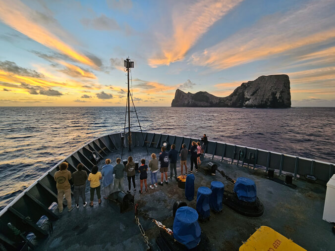 People standing on the bow of a ship