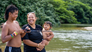 family of three by fish pond