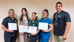 group of people holding certificates