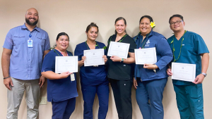 group of people holding certificates