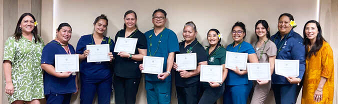 group of people holding certificates