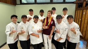 Hensel with culinary students all flashing shaka