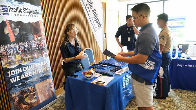 2 people talking by a display table