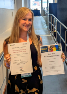 person holding up awards