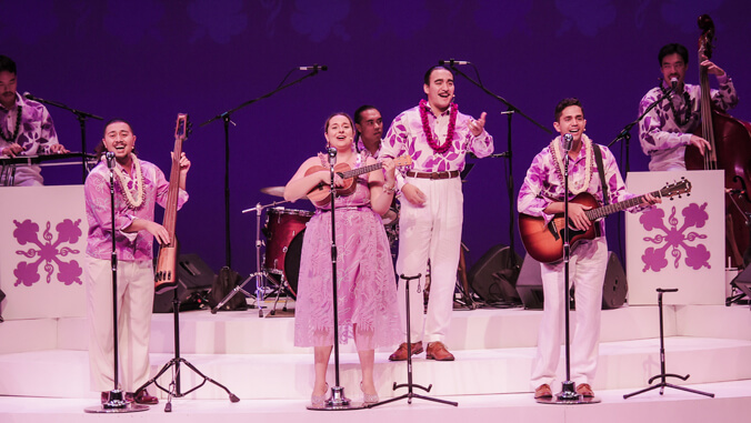 People singing and playing instruments on stage