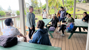 people standing and talking dockside