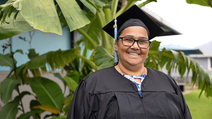 Brenda DeCambra in graduation gown and cap