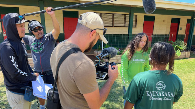 film crew talking to students