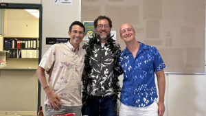 three people smiling for the camera