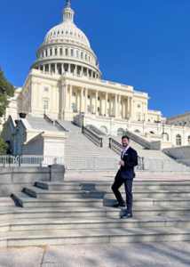 person standing on the steps of the capitol