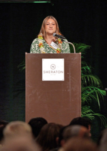 person speaking at a podium