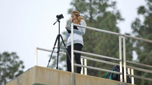 person standing on a platform next to a camera