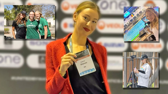 person smiling holding a credential