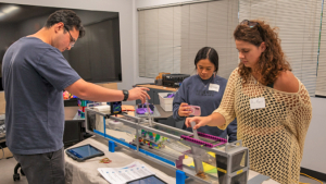 Three people participate in hands on demonstration