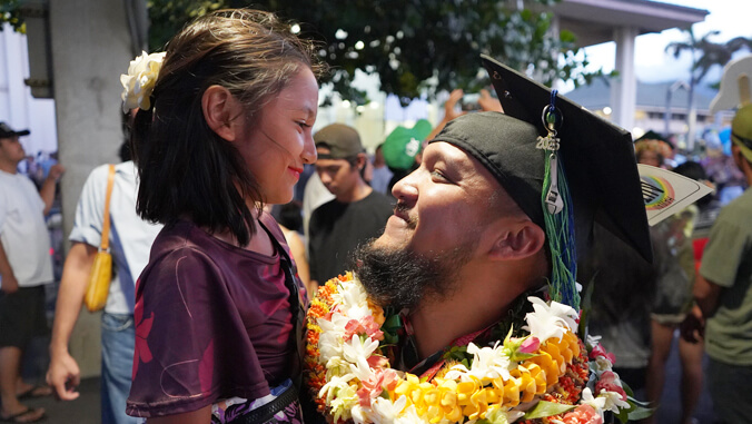 Father smiling up at daughter