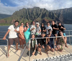 Group of people on a boat in front of the Ko o lau mountains