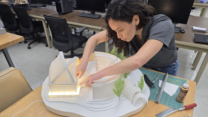Person working on a white 3 d model